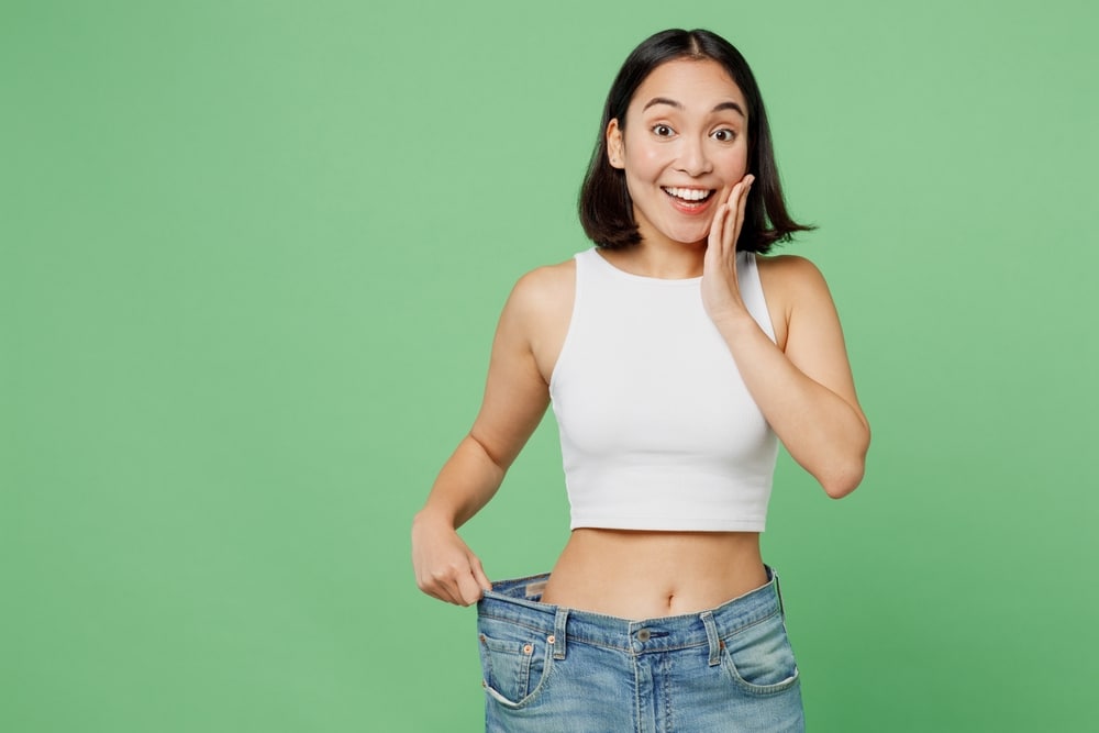 Young,Happy,Woman,Wears,White,Clothes,Show,Loose,Pants,On